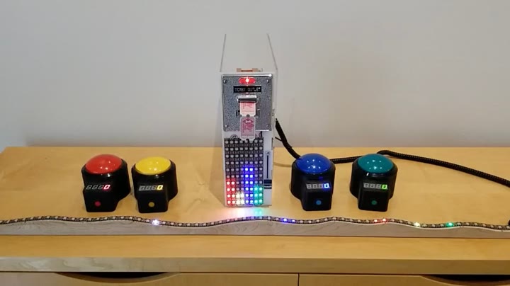 Andy's real Beam Bandit: four big arcade buttons and an LED strip on a wooden shelf